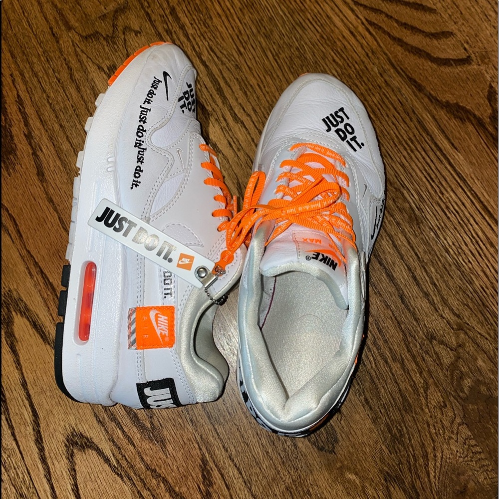 Nike sneakers that are orange, white, and black.